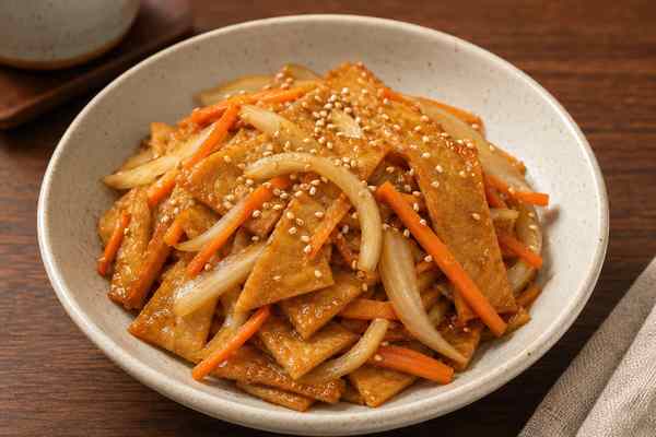 Finished Eomuk Bokkeum Stir-Fried Fish Cake presented in a warm Korean dining setting.