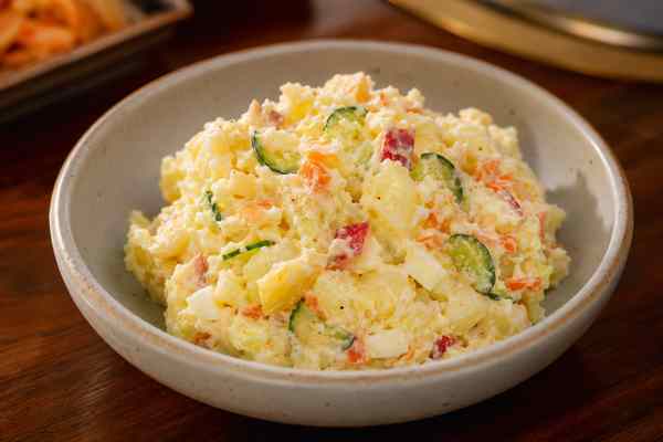Finished Korean Potato Salad presented in a warm Korean dining setting.
