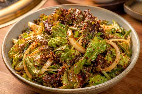 Finished Sangchu Geotjeori Fresh Lettuce Salad presented in a warm Korean dining setting.