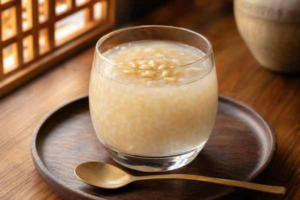 Finished Sikhye Sweet Rice Punch presented in a warm Korean dining setting.