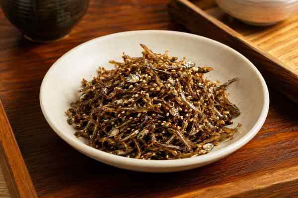 Finished Myeolchi Bokkeum Stir-Fried Anchovies presented in a warm Korean dining setting.