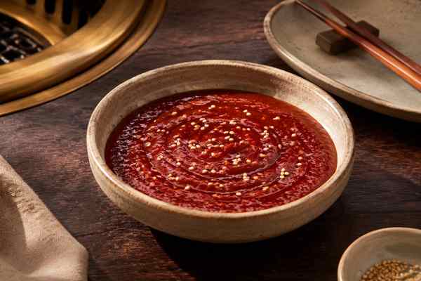 Finished Cho-Gochujang Sweet-Tangy Chili Sauce presented in a warm Korean dining setting.