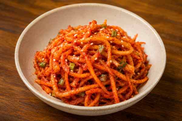Finished Doraji Muchim Spicy Bellflower Root presented in a warm Korean dining setting.