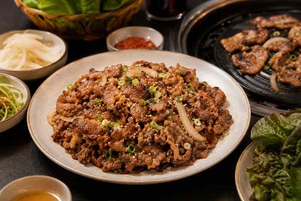 Finished Ganjang Pork Bulgogi presented in a warm Korean dining setting.