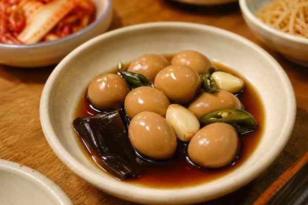 Finished Mechurial Jangjorim Soy-Braised Quail Eggs presented in a warm Korean dining setting.