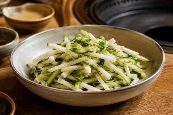 Finished Asian Pear and Cucumber Salad presented in a warm Korean dining setting.