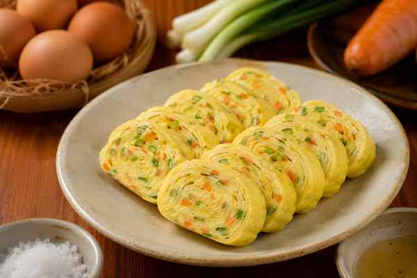 Finished Gyeran Mari Rolled Omelet presented in a warm Korean dining setting.