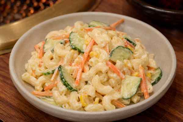 Finished Korean BBQ Restaurant-Style Macaroni Salad presented in a warm Korean dining setting.