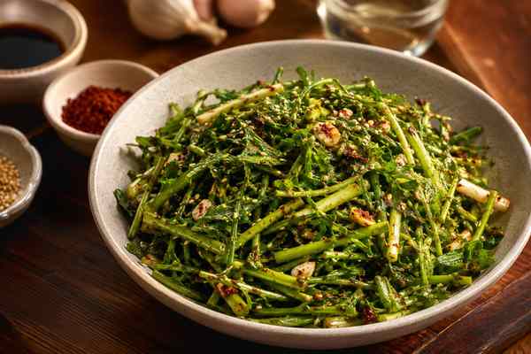 Finished Minari Muchim Water Parsley Salad presented in a warm Korean dining setting.