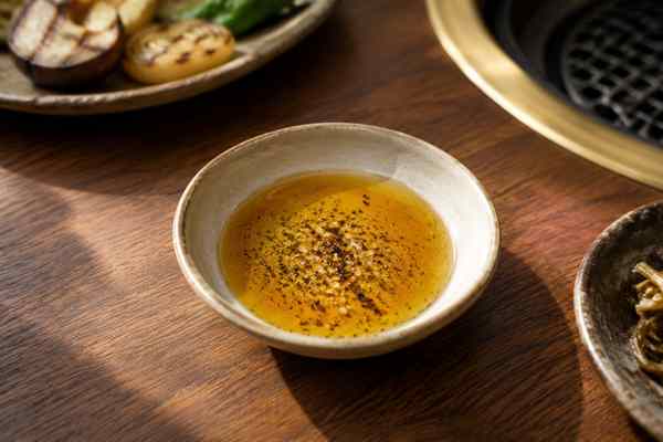 Finished Gireumjang Sesame-Oil Salt Dip presented in a warm Korean dining setting.