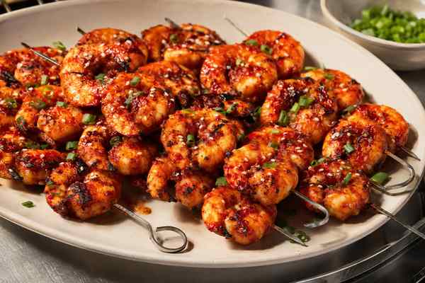 Finished Gochujang Grilled Shrimp presented in a warm Korean dining setting.
