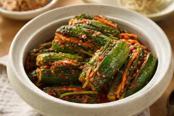 Finished Oi Sobagi Cucumber Kimchi presented in a warm Korean dining setting.
